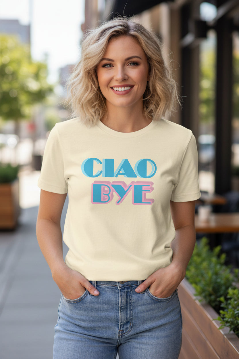 A cream-colored short-sleeve t-shirt with a retro graphic reading 'CIAO BYE' in blue and pink bubble letters.Miami Vice style inspiration.