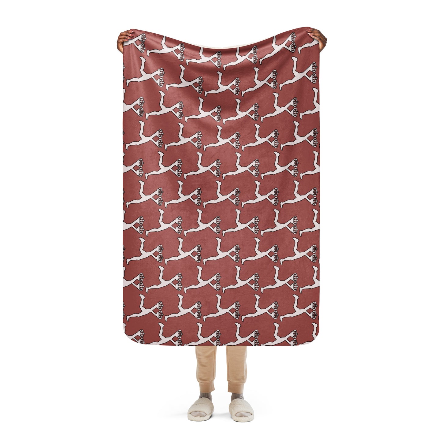 Person holding a red blanket with white Lux character pattern on a white background