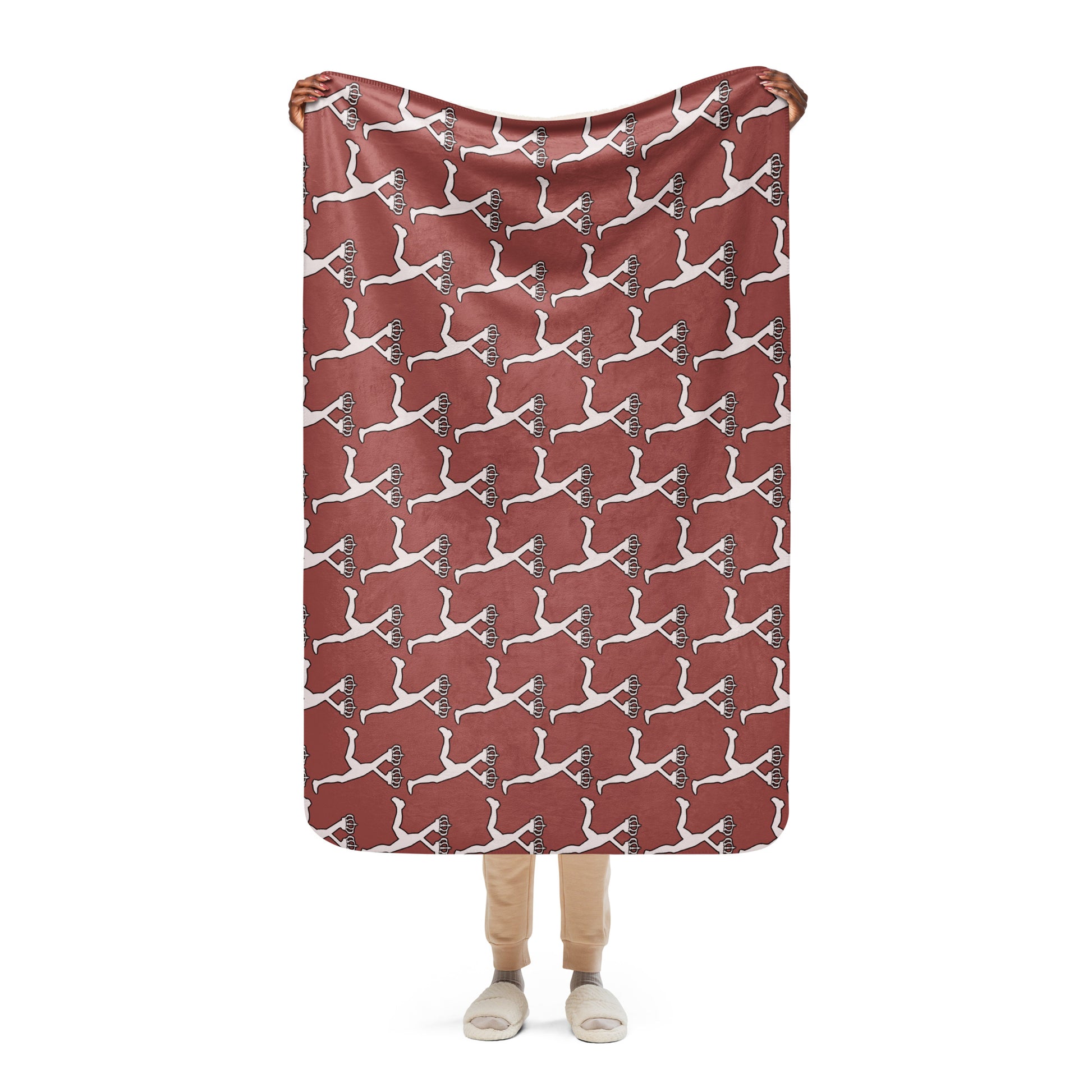 Person holding a red blanket with white Lux character pattern on a white background