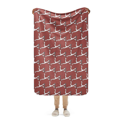 Person holding a red blanket with white Lux character pattern on a white background