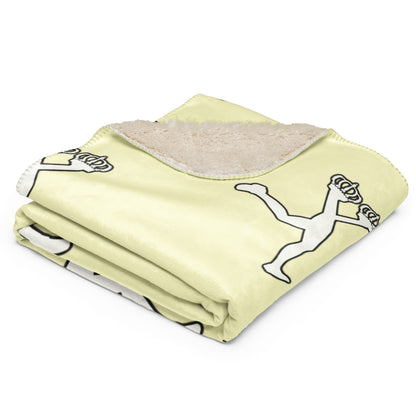 Folded cream blanket with black and white graphics of the character of Lux on a white background