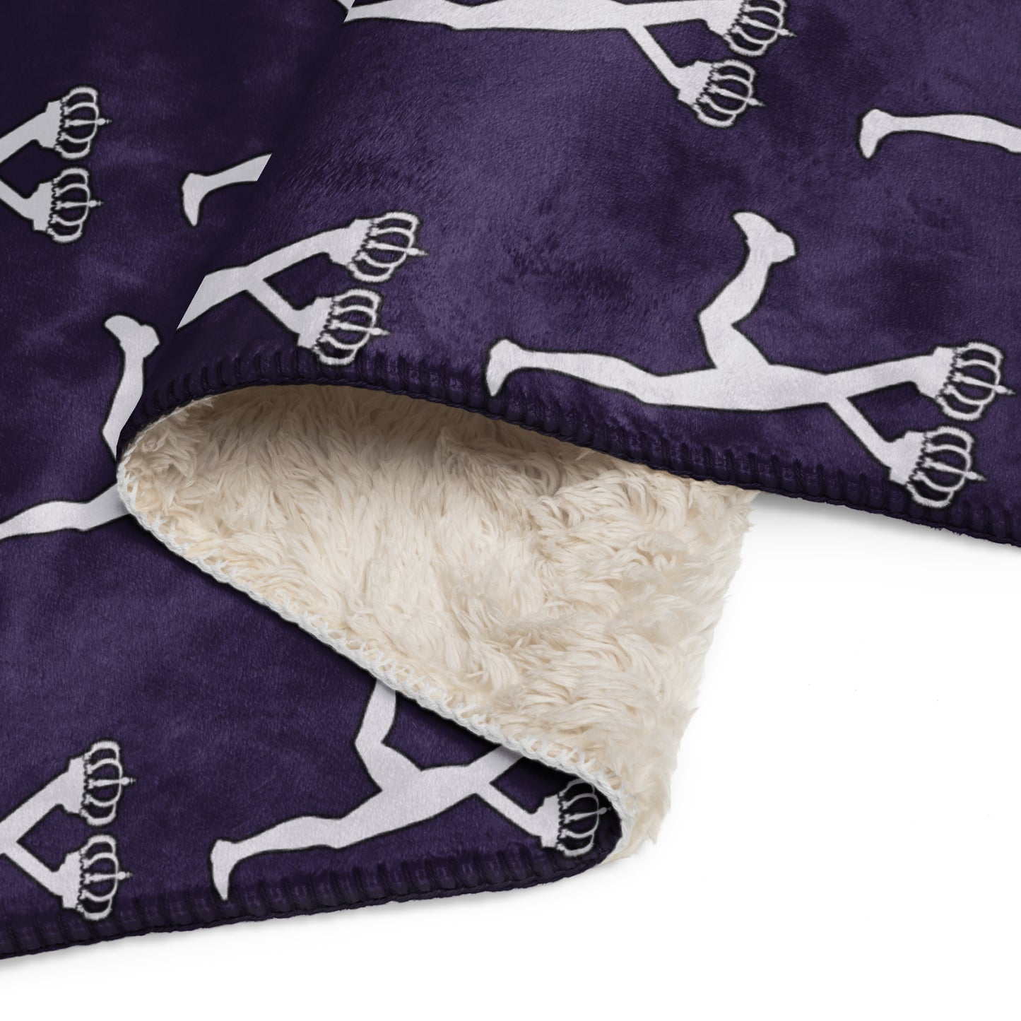 Folded blanket with white silhouette pattern on a purple background