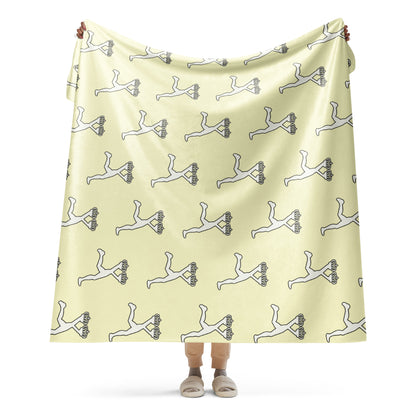 Person holding a cream blanket with black and white patterns of the most wanted Lux  Runner character on a white background 