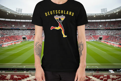 Man wearing a black t-shirt with a colorful graphic design, standing against a stadium for the world cup 2026