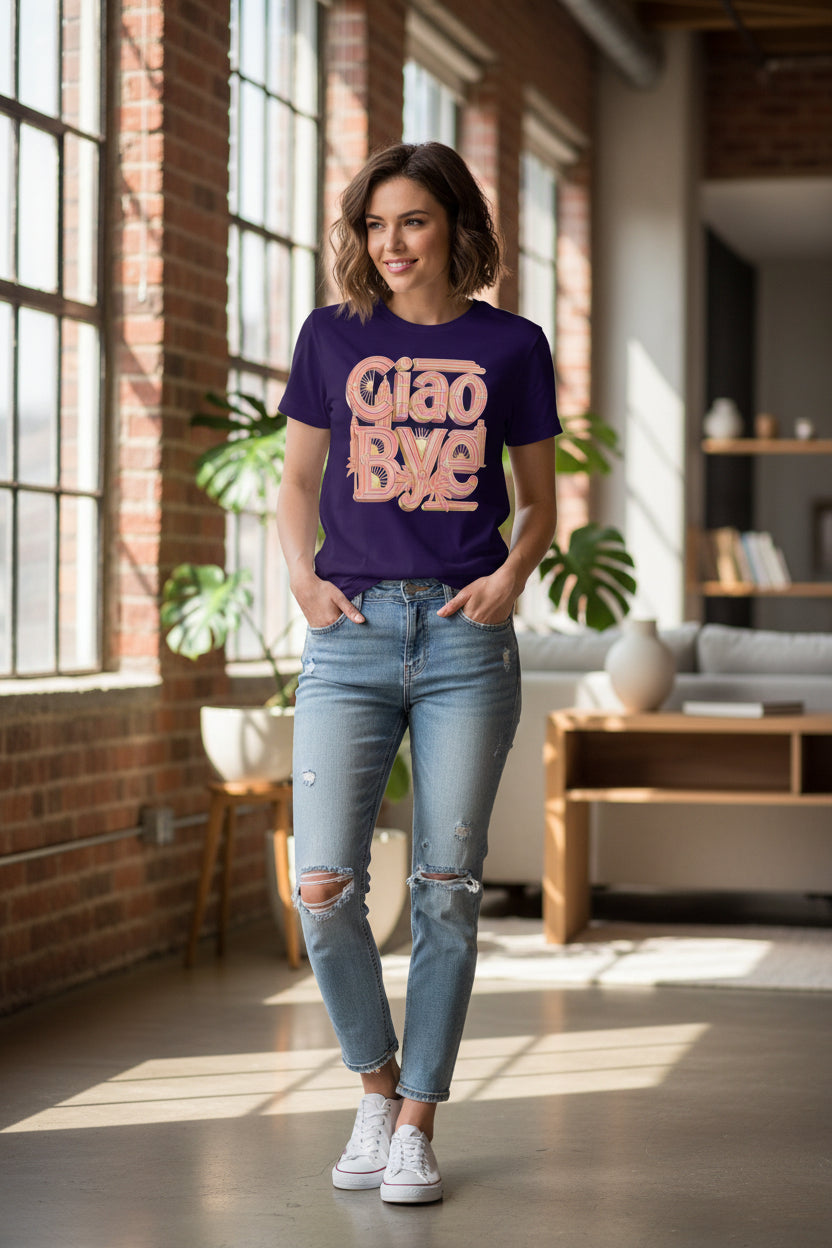 A dark purple short-sleeve t-shirt with a retro-style graphic on the front reading 'Ciao Bye' in a peach-pink and gold Art Deco font.
