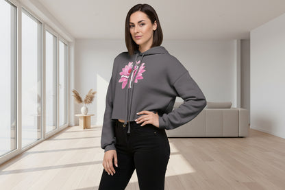 Woman wearing a gray hoodie with a pink flower design on a white background